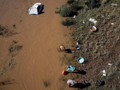 Image for  Rescuers in South Africa search for the missing after floods as the death toll rises to 57